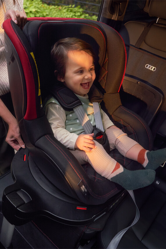 Audi genuine accessories, showcasing a child strap onto a child seat