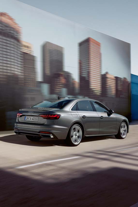 Audi A4 Sedan back side view parked in front of a city skyline billboard poster