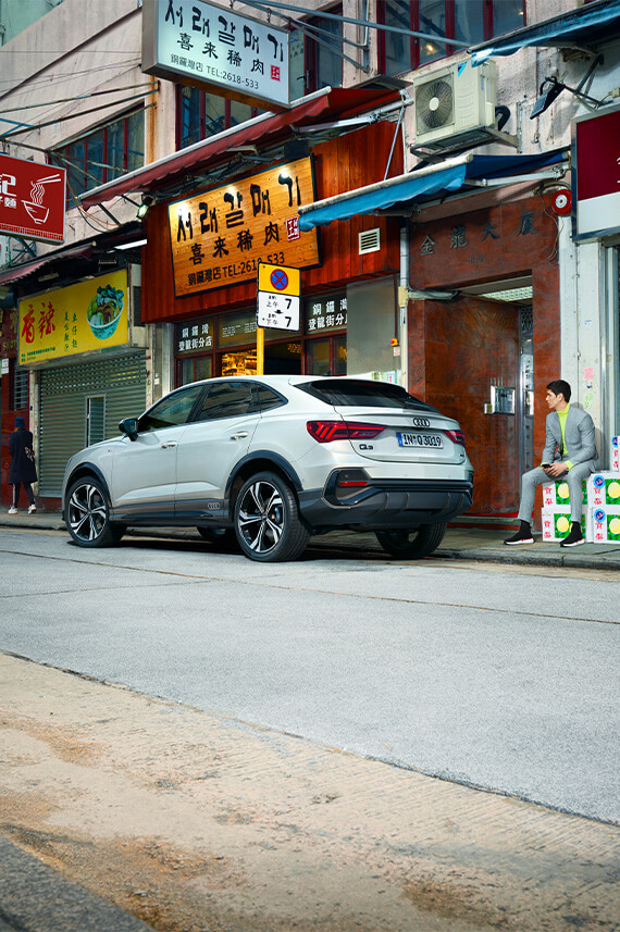 rear view of Audi Q3 Sportback parked along Korean restaurants