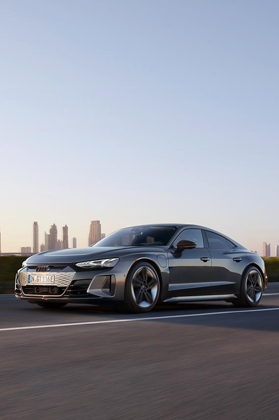 front side view of Audi RS e-tron GT with city skyline in the background